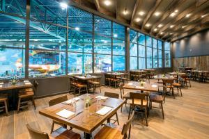 a restaurant with tables and chairs and large windows at Great Wolf Lodge Chicago/Gurnee in Gurnee