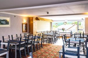 a restaurant with tables and chairs in a room at Elan Hotel in Rhayader