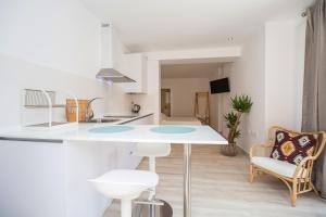 a kitchen with a table and chairs in a room at Malabau Beach House in Tarifa