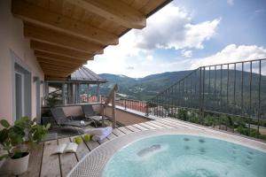 a pool on a balcony with a view of the mountains at Hotel Luna Bianca Folgaria in Folgaria
