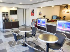 a waiting room with two tables and two televisions at Studio 6-Fresno, CA - Extended Stay in Pinedale