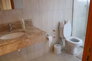 a bathroom with a sink and a toilet at Solar do Centro in Gramado +11 photos