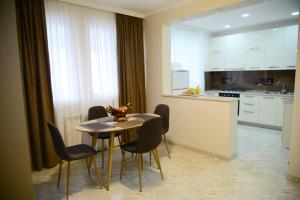 a kitchen with a table and chairs in a room at Metekhi Vista in Tbilisi City