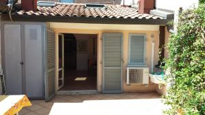 an open door of a house with blue shutters at CASA CENTRO STORICO RIMINI in Rimini +26 photos
