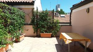 a patio with plants and a bench on a building at CASA CENTRO STORICO RIMINI in Rimini