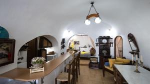 un soggiorno con letto, tavolo e sedie di Mylopetres Traditional Houses Finikia a Oia