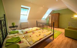 A bed or beds in a room at Penzion Sonja