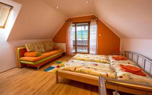 A bed or beds in a room at Penzion Sonja