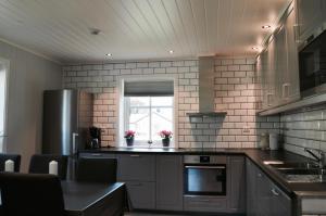 a kitchen with stainless steel appliances and a window at Naustvoll in Olden