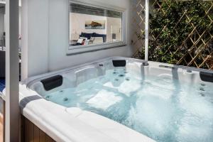 a bathtub with a glass of water in front of it at Grifo Hotel Charme & SPA in Ischia