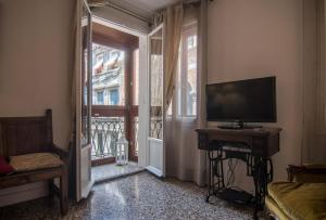 a living room with a television and a window at Cà Lina in Venice