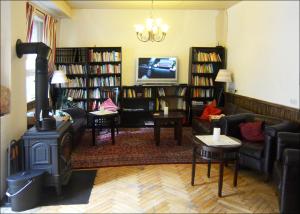 a living room with a fireplace and a stove at Hotel Herberge zur Traube in Bad Wimpfen