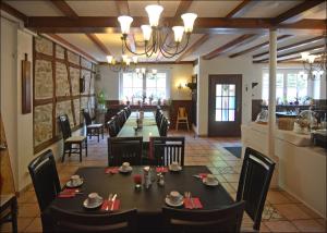 a dining room with a long table and chairs at Hotel Herberge zur Traube in Bad Wimpfen