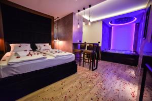 a bedroom with a bed and a purple room at Vila Romantika in Zlatibor