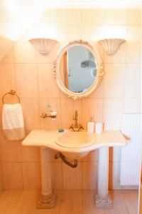 a bathroom with a sink and a mirror at Traditional Villa Priotissa in Tympáki