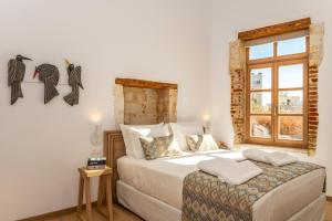 a bedroom with a large bed and a window at Aelios Design Hotel in Chania