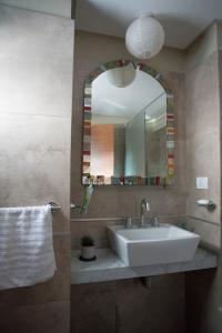 a bathroom with a sink and a mirror at Apart Bicentenario in San Miguel de Tucumán