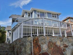 a house with a deck on a stone wall at Oasis in Victoria