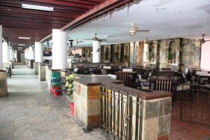 a dining room with tables and chairs in a restaurant at Corus Paradise Resort Port Dickson in Port Dickson