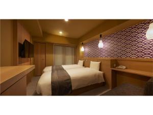Postel nebo postele na pokoji v ubytování Sakura Sky Hotel