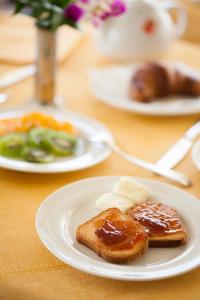 einen Tisch mit zwei Teller Essen mit Brot und Butter in der Unterkunft Hotel Candido in Diano Marina