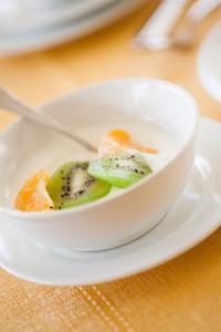 a bowl of soup on a plate on a table at Hotel Candido in Diano Marina