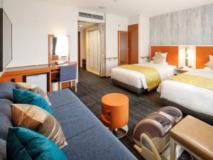 Postel nebo postele na pokoji v ubytování HOTEL MYSTAYS Maihama