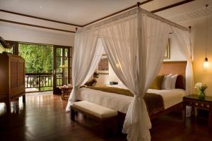 A bed or beds in a room at Villas at The Patra Bali Resort and Villas - CHSE Certified
