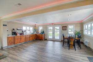 a large kitchen with wooden cabinets and a table at Westbridge Inn & Suites in Clinton