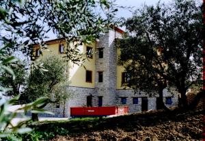 a yellow and white building with trees in front of it at Agriturismo Terra e Sapori in Campodipietra