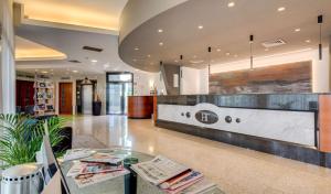 a lobby of a building with a reception desk at Best Western Hotel Turismo in San Martino Buon Albergo