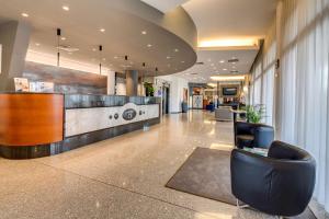 an office lobby with a reception desk and chairs at Best Western Hotel Turismo in San Martino Buon Albergo