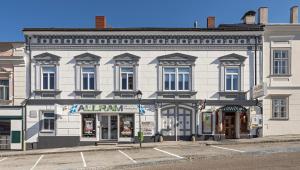 a large white building on the corner of a street at Allram "TopSleep" 24 hours checkin in Waidhofen an der Thaya