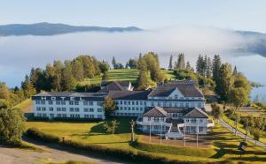 an aerial view of a large white building on a hill at Thon Partner Hotel Selbusjøen in Selbu