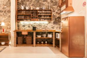 a kitchen with wooden cabinets and a refrigerator at Casa Amelia in Santa Cruz de la Palma