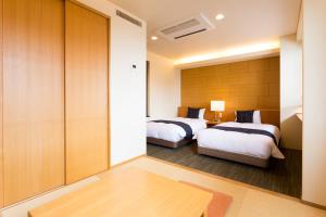 Tempat tidur dalam kamar di Takanokono Hotel