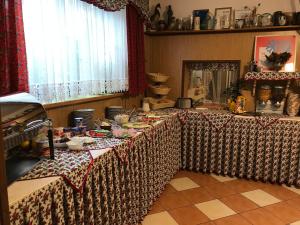 a dining room with two tables with food on them at Hanusina Chałupa Wynajem pokoi in Zakopane