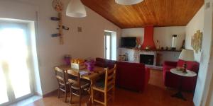 a living room with a table and a dining room at Holiday House in Santa Severina