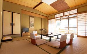 a living room with a table and chairs at Kamiobo in Kobe