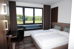 Postel nebo postele na pokoji v ubytování Hotel Donauhof Mauthausen