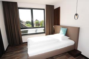 Postel nebo postele na pokoji v ubytování Hotel Donauhof Mauthausen
