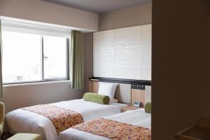 Postel nebo postele na pokoji v ubytování HOTEL MYSTAYS Kyoto Shijo