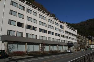 a large white building on the side of a street at Tominoko Hotel in Fujikawaguchiko
