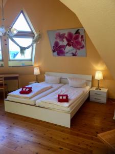 a bedroom with a white bed and white walls at Hotel & Pension NOlift in Dresden