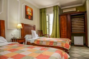 Postel nebo postele na pokoji v ubytování Tchero Hotel