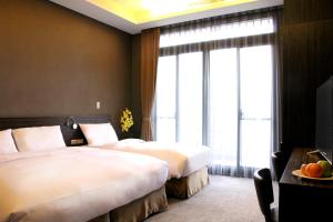 Postel nebo postele na pokoji v ubytování Capital Hotel SongShan