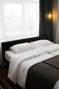 a bedroom with a large bed with a window at Concept Hotel in Khimki