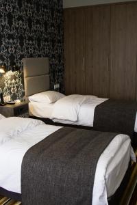 two beds in a hotel room with at Concept Hotel in Khimki