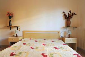 a bedroom with a bed with a floral bedspread at Silville in Silvi Marina