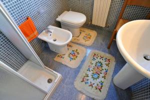 a bathroom with a toilet and a sink at Silville in Silvi Marina +40 photos